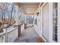 Inviting front porch with white railings, brick accents, and a welcoming entrance to the home at 4844 Mt Evans St, Brighton, CO 80601
