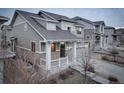 Stylish two-story house with a two-car garage and welcoming covered entry at 26881 E Roxbury Pl, Aurora, CO 80016