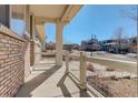 Spacious front porch offering a relaxing outdoor seating area with neighborhood views at 26881 E Roxbury Pl, Aurora, CO 80016