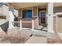 Inviting front porch with brick accents, providing a welcoming entrance to the home at 26881 E Roxbury Pl, Aurora, CO 80016