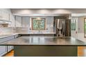 Bright kitchen features stainless appliances, marble countertops, and ample natural light at 7873 E Colgate Pl, Denver, CO 80231