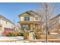 Charming two-story home features a cozy front porch and stone accents, complemented by a well-maintained yard at 1172 S Coolidge Cir, Aurora, CO 80018