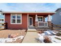 Red siding ranch home with a covered porch and stone accents at 16845 Buffalo Valley Path, Monument, CO 80132