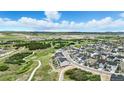This is an aerial view of a neighborhood with sidewalks and green spaces in a scenic location at 624 Simmental Loop, Castle Rock, CO 80104