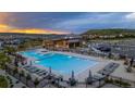 Resort-style community pool and clubhouse with inviting lounge chairs and stunning sunset views at 624 Simmental Loop, Castle Rock, CO 80104
