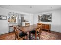 Open-concept dining room with hardwood floors and an elegant, connecting breakfast bar at 5132 Eaton St, Denver, CO 80212