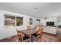 Bright dining room with hardwood floors, a large window, and an adjacent living area at 5132 Eaton St, Denver, CO 80212