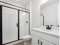 Modern bathroom featuring a glass-enclosed shower and sleek vanity at 1100 Joseph Pl, Erie, CO 80026