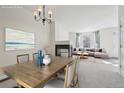 Virtually staged dining room, open concept with living room and fireplace at 4321 W 118Th Pl, Westminster, CO 80031