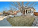 Charming two-story home featuring a brick facade, attached two-car garage and manicured lawn at 5005 S Elk St, Aurora, CO 80016