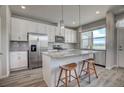 Bright kitchen featuring stainless steel appliances, gray countertops, and a kitchen island with seating at 2790 Center Park Way, Berthoud, CO 80513