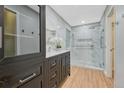Modern bathroom featuring a marble walk-in shower, and a dark vanity for a luxurious feel at 123 Wheat Ridge St, Palmer Lake, CO 80133