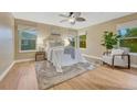 Serene bedroom with neutral decor, ample natural light, and a cozy sitting area for relaxation at 123 Wheat Ridge St, Palmer Lake, CO 80133