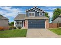 Charming two-story home featuring a blue exterior, brick accents, and a well-maintained front yard at 5124 S Jebel St, Centennial, CO 80015