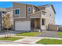 Two-story home with attached garage, stone accents, and front yard at 17919 Dandy Brush Dr, Parker, CO 80134