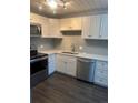 Beautiful updated kitchen features stainless steel appliances, tile backsplash, and neutral color palette at 665 S Clinton St # 14A, Denver, CO 80247