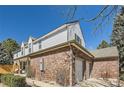 Two-story home featuring brick and siding, with an attached two-car garage and well-maintained landscaping at 7559 S Ivanhoe Cir, Centennial, CO 80112