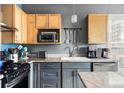 Efficient kitchen featuring stainless appliances, granite countertops, and ample cabinet storage at 1440 Little Raven St # 202, Denver, CO 80202