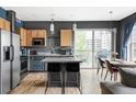 Inviting open kitchen and dining area with stainless steel appliances and plenty of natural light at 1440 Little Raven St # 202, Denver, CO 80202