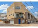 Modern townhouse exterior with a private balcony, garage access, and well-kept landscaping at 3142 W 20, Denver, CO 80211
