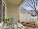 Inviting covered patio with comfortable seating and a view of the well-manicured backyard at 12819 E Dickensen Pl, Aurora, CO 80014