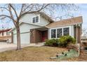 Attractive two-story home with a brick facade, well-maintained landscaping, and a garage at 2228 S Eldridge St, Lakewood, CO 80228