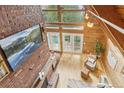 A bright living room featuring an exposed brick wall with hardwood floors and lots of natural light at 1472 Sinton Rd, Evergreen, CO 80439