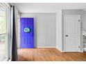 Bright entryway with hardwood floors and a vibrant front door at 18130 E Asbury Dr, Aurora, CO 80013