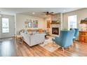 Inviting living room with a stone fireplace, comfortable seating, and hardwood floors at 965 Arapahoe Cir, Louisville, CO 80027