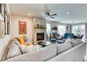 Bright living room with a stone fireplace, modern furniture, and ample natural light at 965 Arapahoe Cir, Louisville, CO 80027