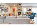 Inviting living room with a stone fireplace, comfortable seating, and large windows at 965 Arapahoe Cir, Louisville, CO 80027