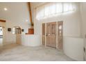 A spacious entryway with tile floors, detailed front doors, and a unique partition wall at 12291 S Critchell Ln, Littleton, CO 80127