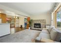 Inviting living room featuring stone fireplace, hardwood floors, neutral sofa, and a glimpse of the kitchen at 805 Union Ave, Boulder, CO 80304