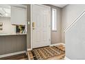 Entryway boasts wood-look flooring, a decorative rug, and a conveniently placed coat closet at 2491 S Xanadu Way # A, Aurora, CO 80014