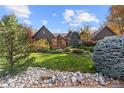 House exterior with manicured lawn and rock landscaping at 11 E Belleview Ln, Greenwood Village, CO 80121