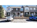 Two story brown and beige condo building with parking at 14700 E 104Th Ave # 2605, Commerce City, CO 80022