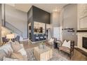 This expansive living room features vaulted ceilings, a fireplace, and an open layout with modern decor at 9481 E Mansfield Ave # 301, Aurora, CO 80014