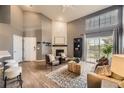 Bright living room features wood floors, a brick fireplace, and access to the balcony through a sliding glass door at 9481 E Mansfield Ave # 301, Aurora, CO 80014