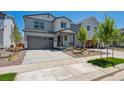 Attractive two-story home with landscaped front yard, a porch, and an attached garage at 2162 Flower Blossom Ave, Brighton, CO 80601