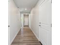 Bright hallway featuring modern wood-look flooring and neutral wall paint at 2162 Flower Blossom Ave, Brighton, CO 80601