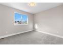 Bright, carpeted bedroom features a large window offering plenty of natural light at 23870 E Dorado Pl, Aurora, CO 80016