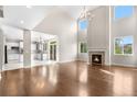 Bright living room boasts hardwood floors, fireplace, and an open layout to the kitchen at 23870 E Dorado Pl, Aurora, CO 80016