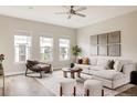Bright living room with large windows, comfortable seating, area rug and stylish decor at 6307 Dayton Ct, Denver, CO 80238