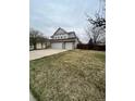 Spacious front yard leads to a home with a three car garage and stone accents at 19193 E Amherst Dr, Aurora, CO 80013