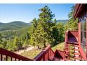 Expansive views from the deck, perfect for enjoying the natural beauty of the surrounding mountains at 7350 Timber Trail Rd, Evergreen, CO 80439