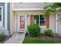 Close-up of townhome entrance, showing the address number, red shutters, and meticulously maintained landscaping at 9278 W Ontario Dr, Littleton, CO 80128