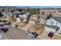 Aerial view of houses with solar panels and mountain backdrop at 12047 W Coal Mine Dr, Littleton, CO 80127