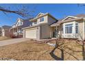 Two-story house with attached garage and partial landscaping at 12047 W Coal Mine Dr, Littleton, CO 80127