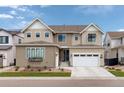 Stunning exterior view of a beige two story home with a two car garage, and a neatly landscaped front yard at 11142 Bright Sky St, Littleton, CO 80125