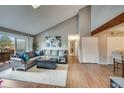Spacious living room with sliding door balcony access, comfortable seating, and convenient closet storage at 3325 S Ammons St # 4-206, Lakewood, CO 80227